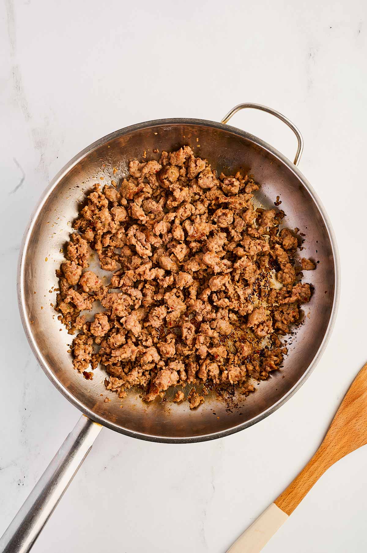 overhead view of cooked sausage in skillet