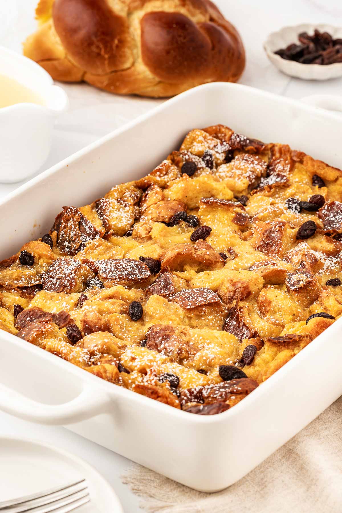 frontal view of bread pudding in white casserole dish