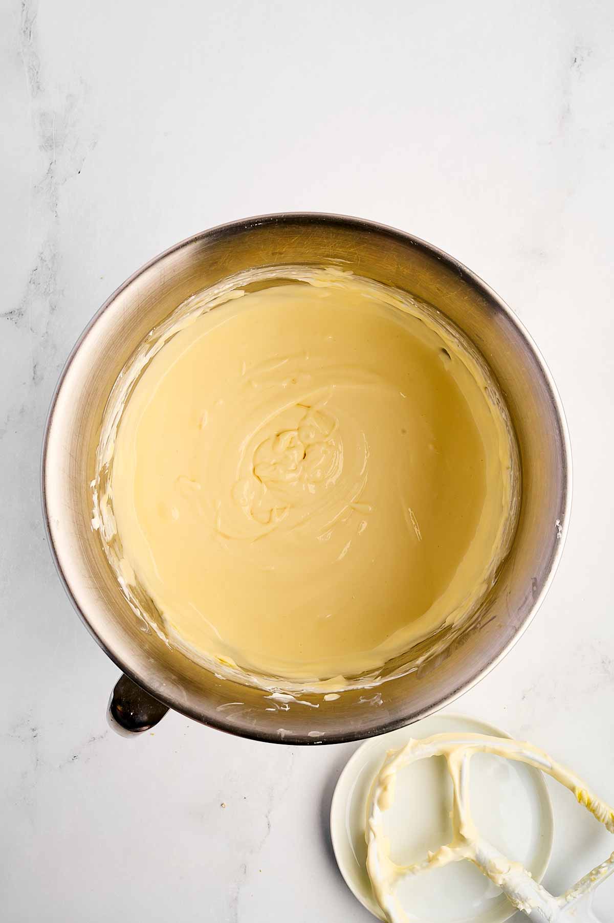 overhead view of cheesecake batter in stand mixer bowl