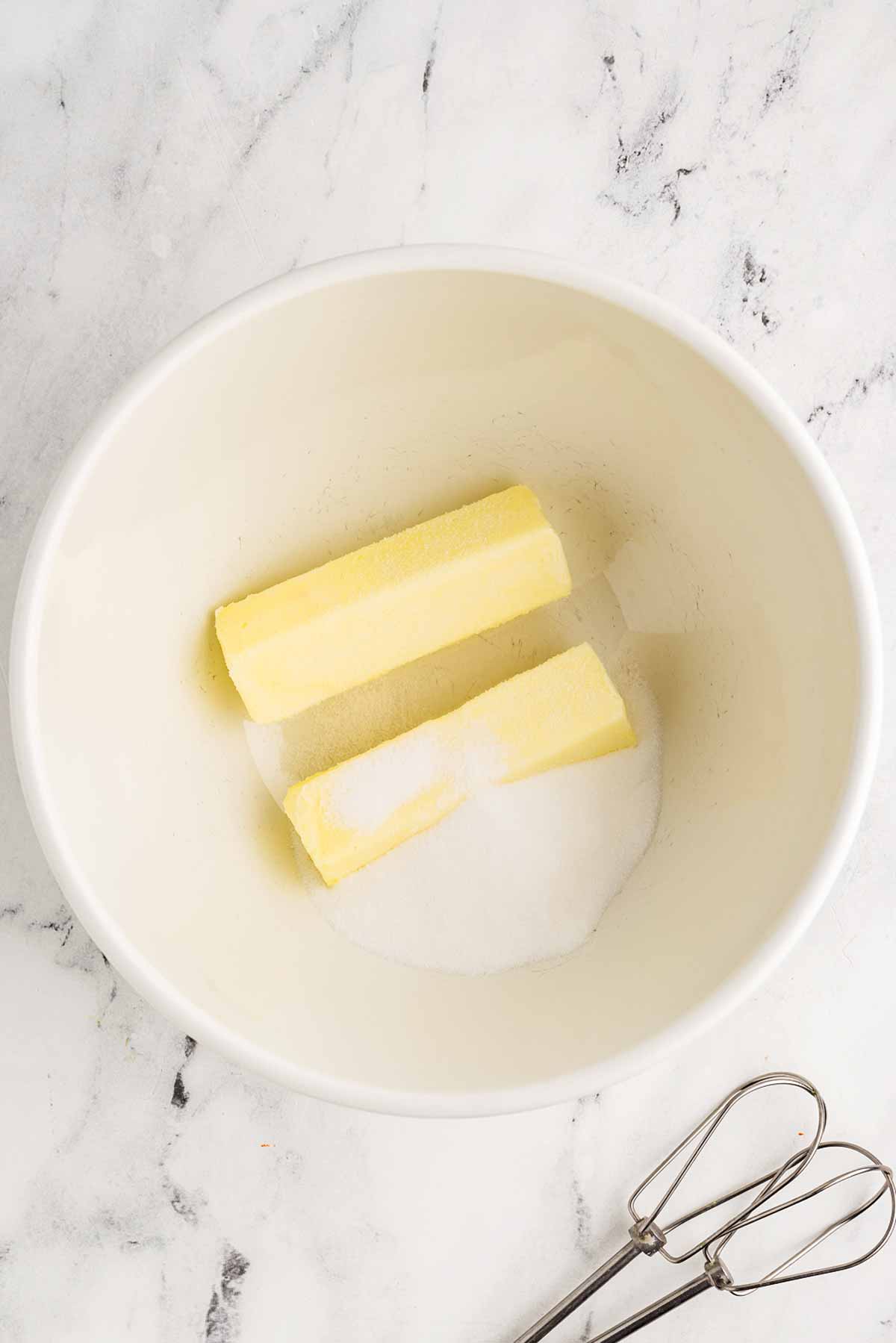 butter and sugar in white mixing bowl