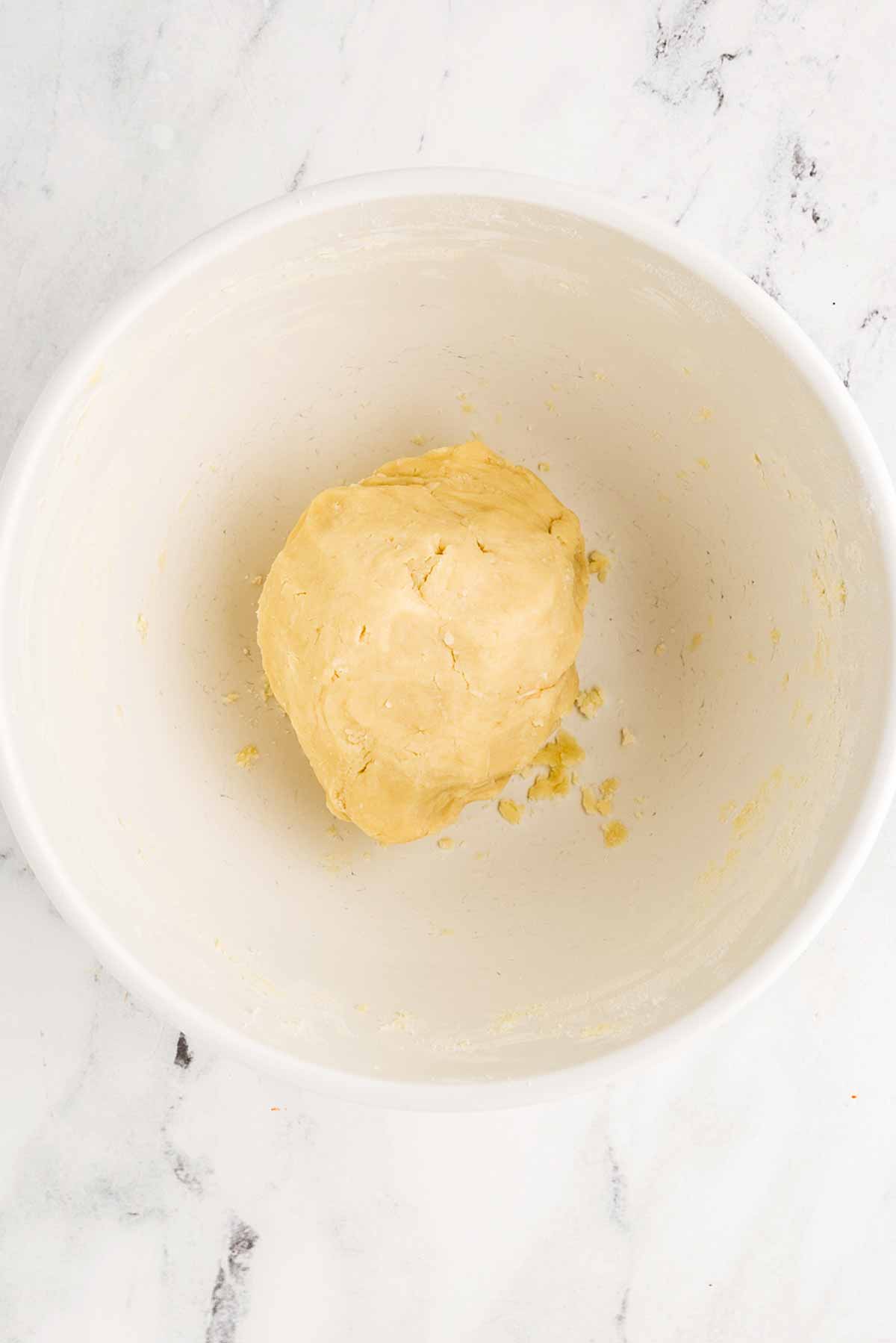 overhead view of shortbread dough in white mixing bowl