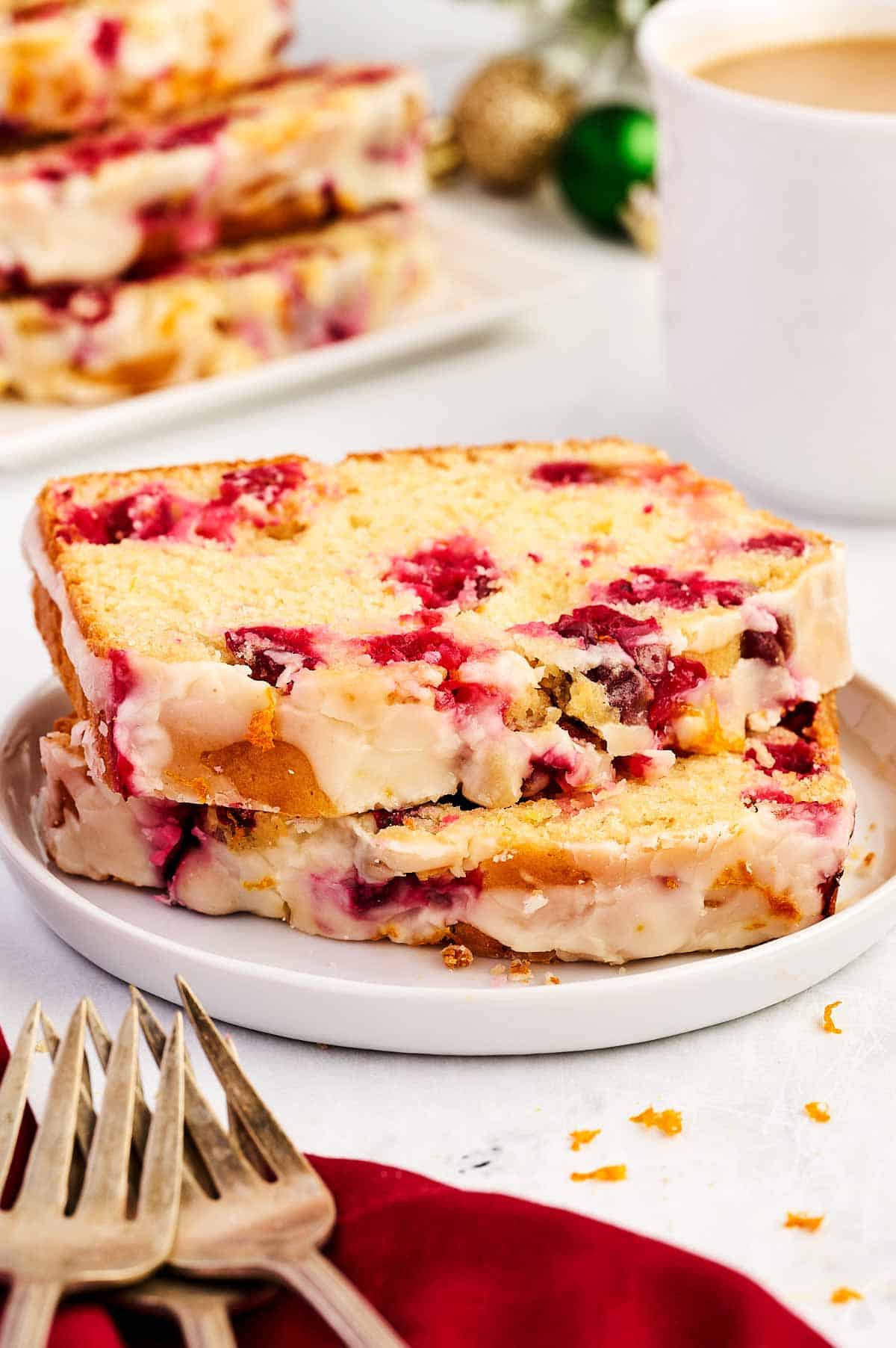 frontal view of cranberry orange bread slices on white plate