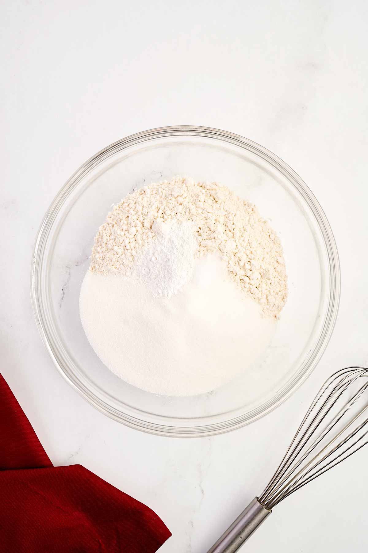 overhead view of dry cake ingredients in a glass bowl