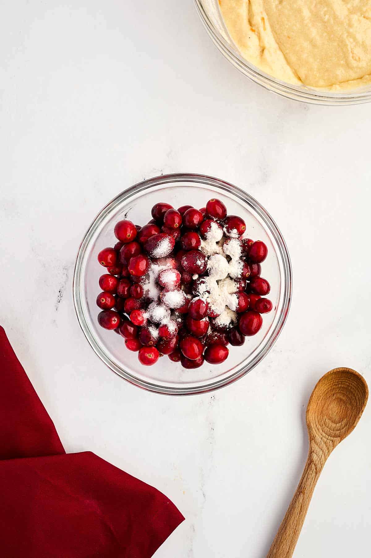 overhead view of cranberries in bowl with flour