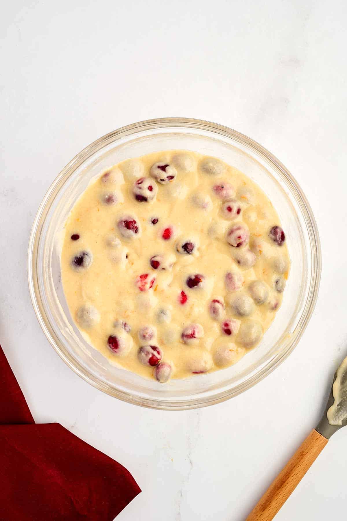 overhead view of cranberry orange bread batter in glass bowl