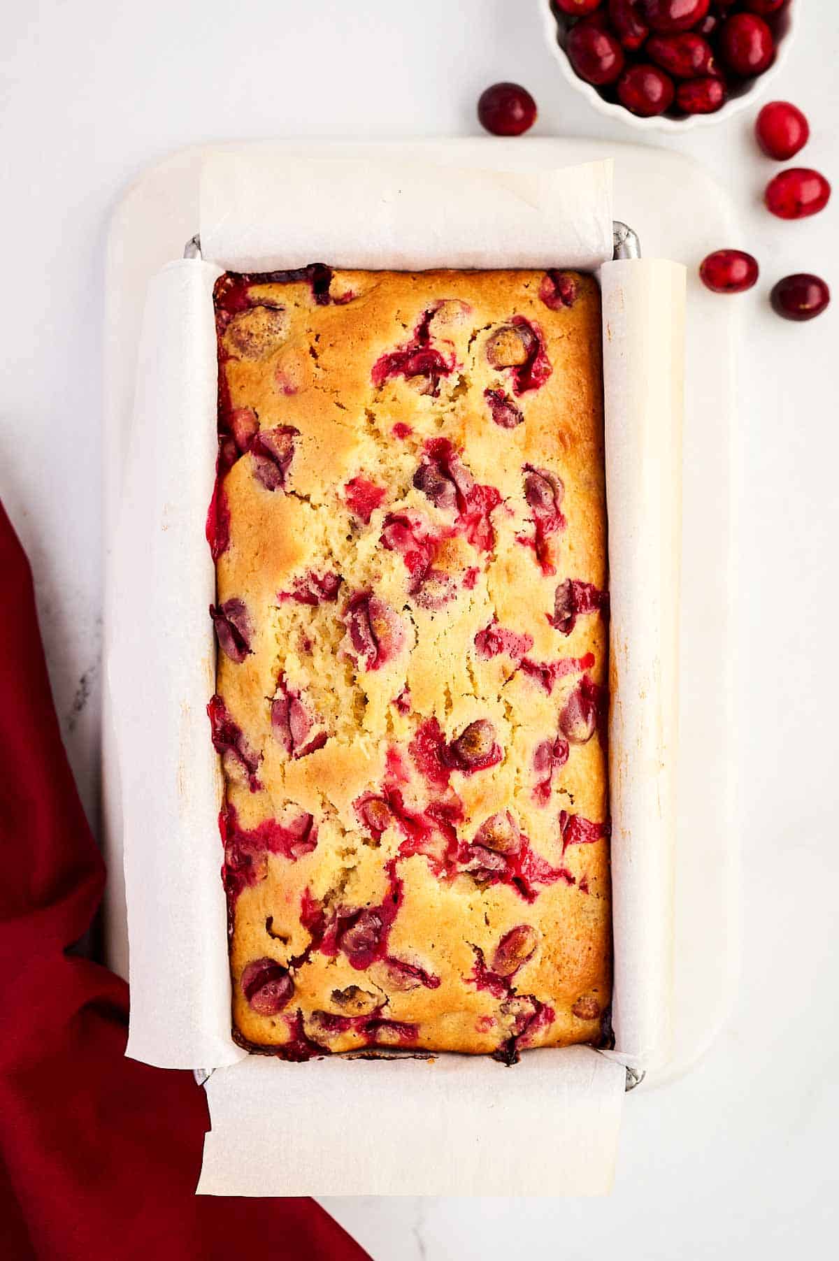 overhead view of baked cranberry orange bread in loaf pan