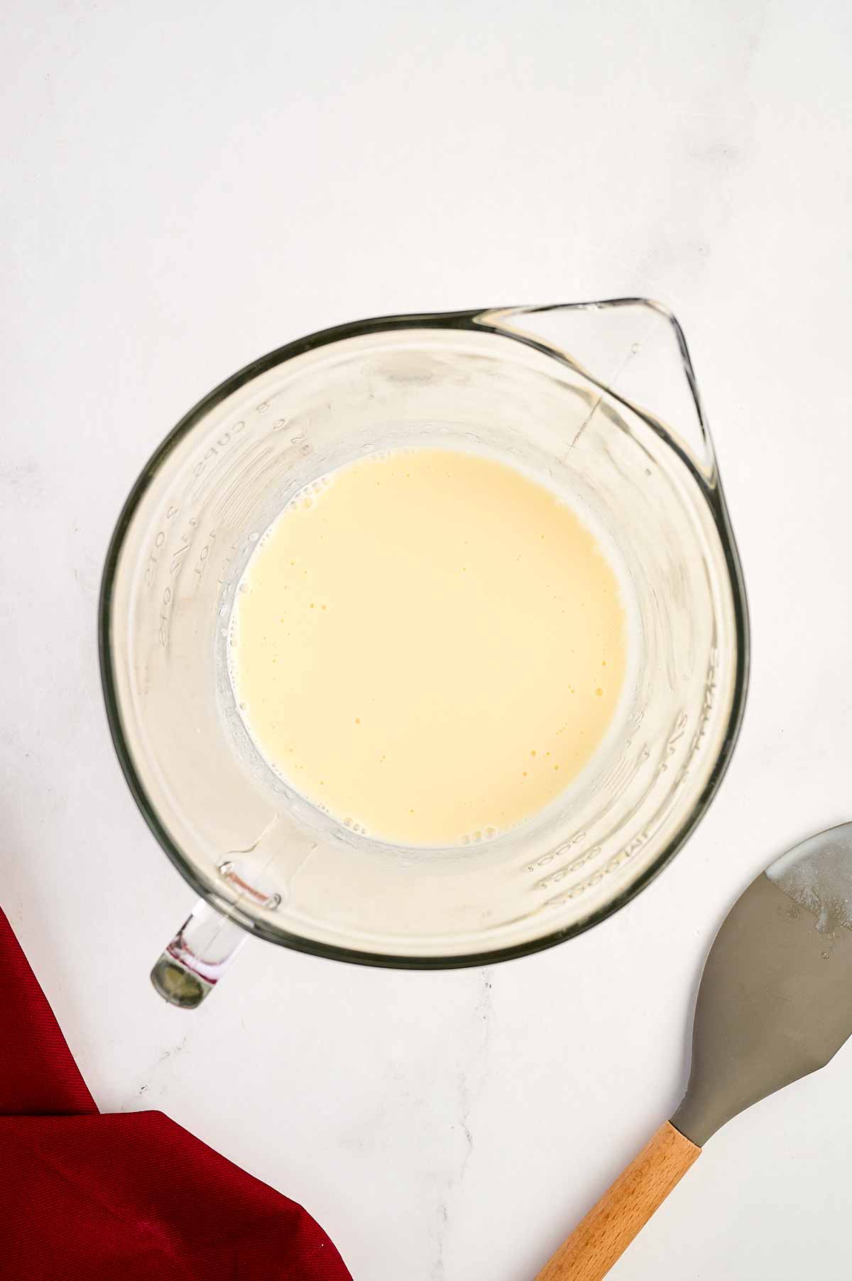 overhead view of homemade buttermilk in glass bowl