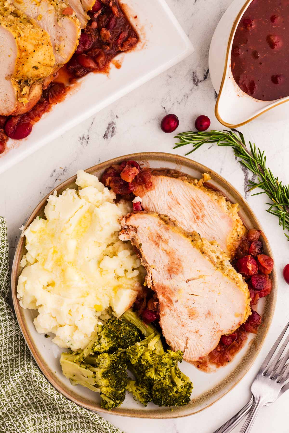 overhead view of plated turkey breast with mashed potatoes and broccoli