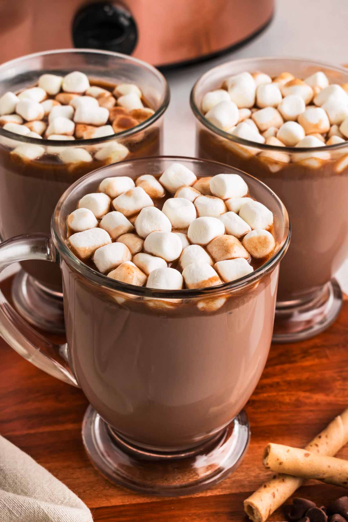 frontal view of mugs with hot chocolate topped with mini marshmallows