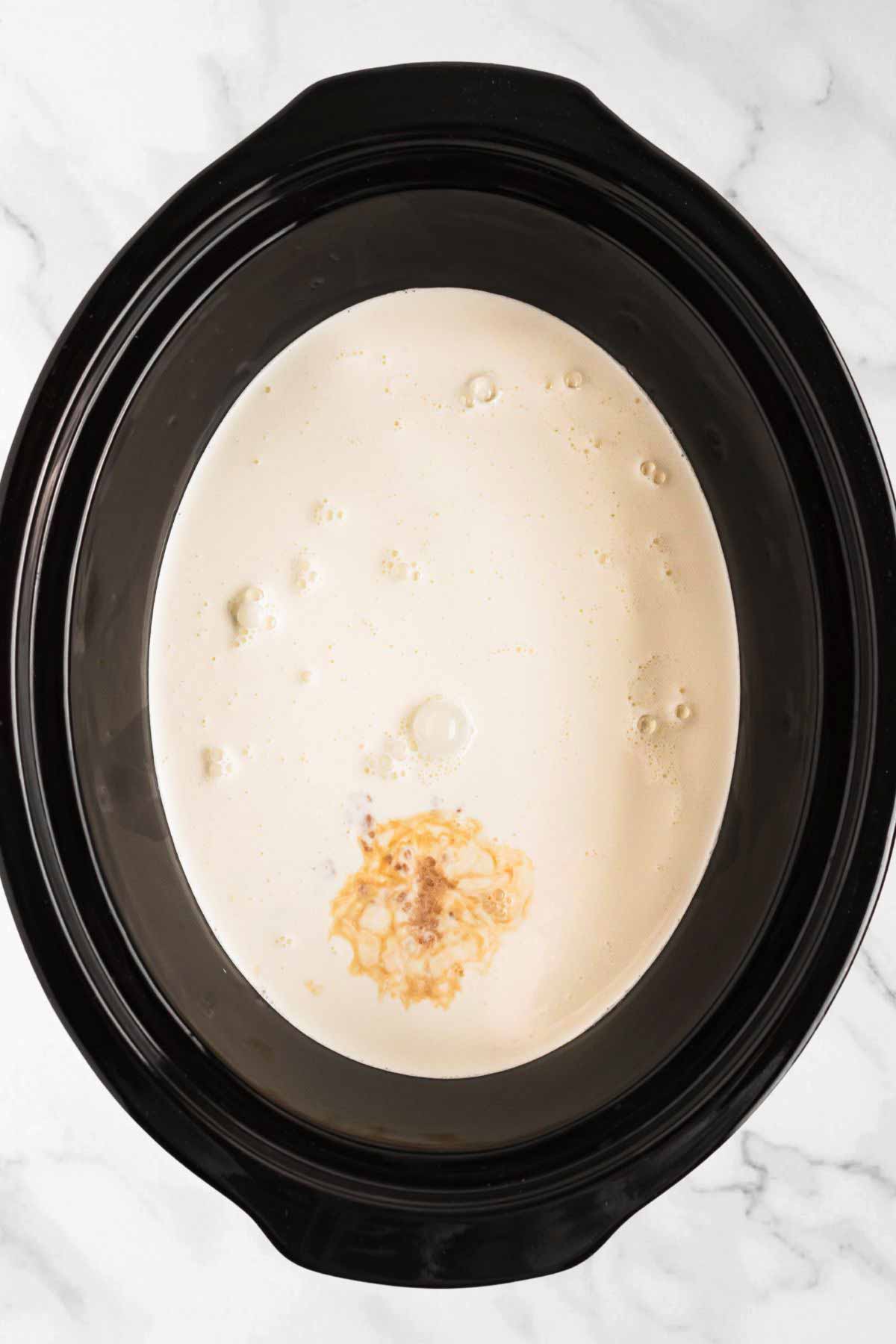 overhead view of cream in slow cooker