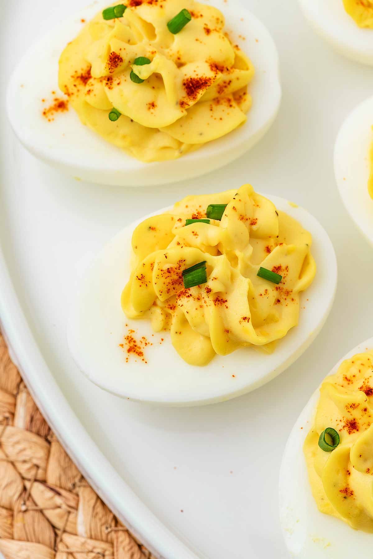 overhead close up view of deviled eggs on white plate