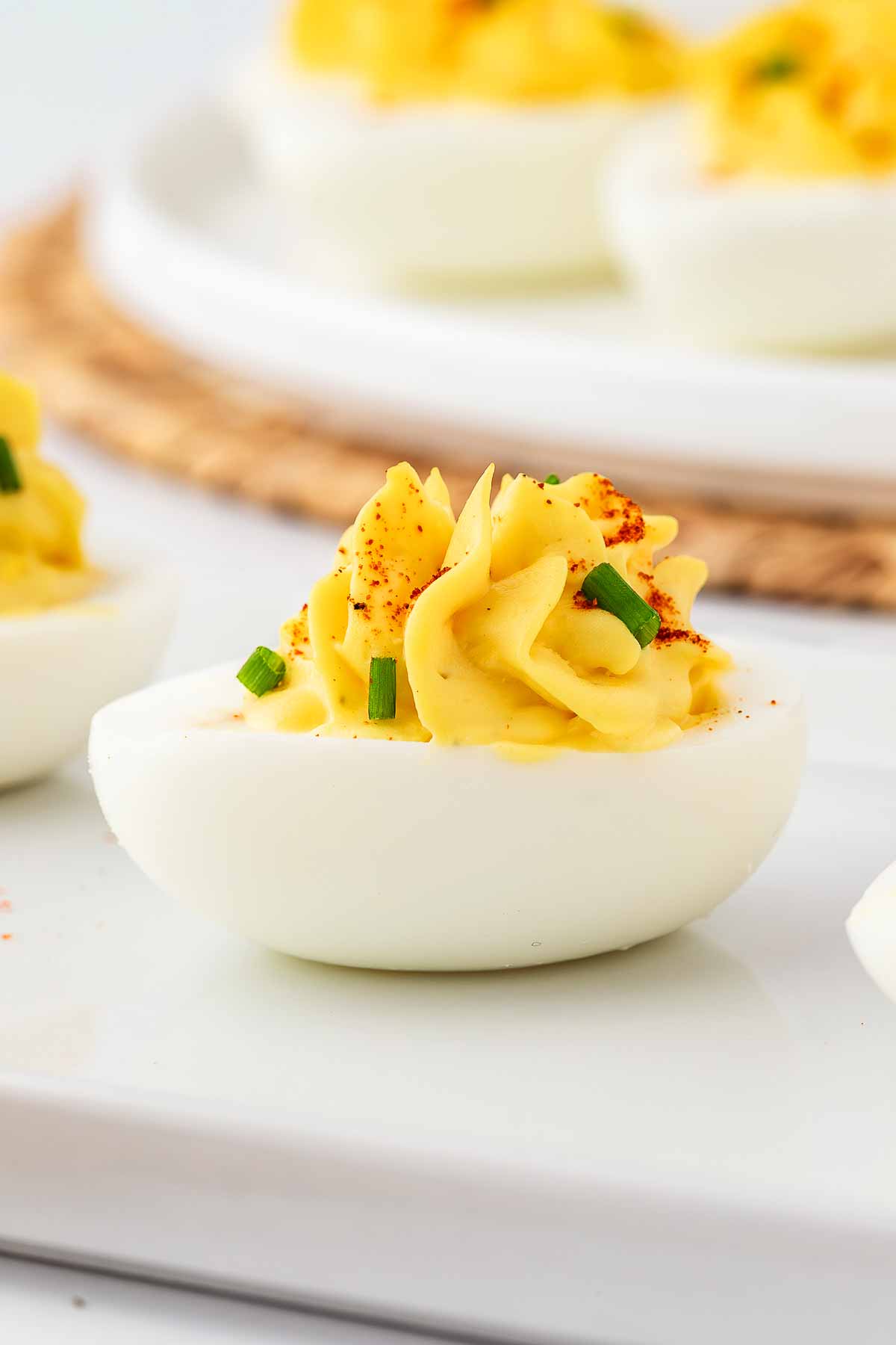 frontal view of deviled eggs on white platter