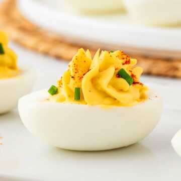 frontal view of deviled eggs on white platter