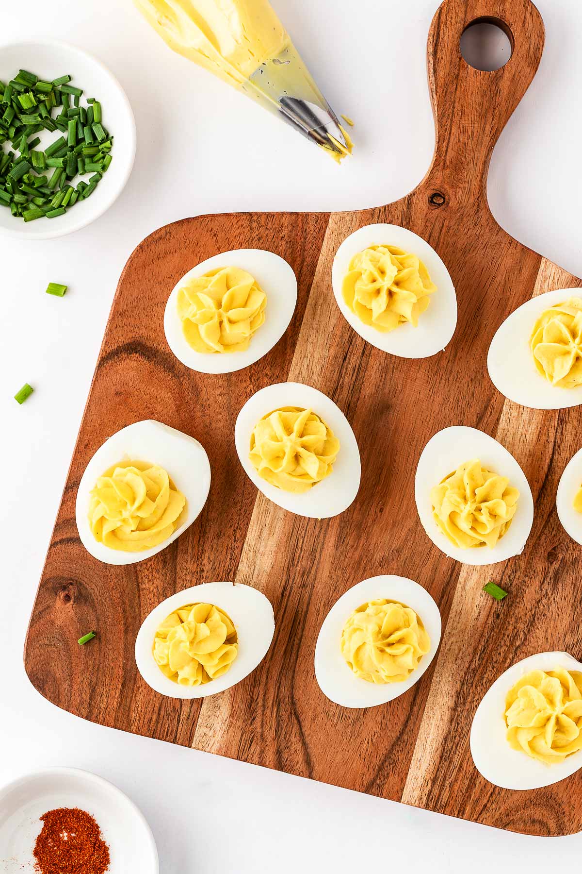 overhead view of ungarnished deviled eggs on wooden cutting board