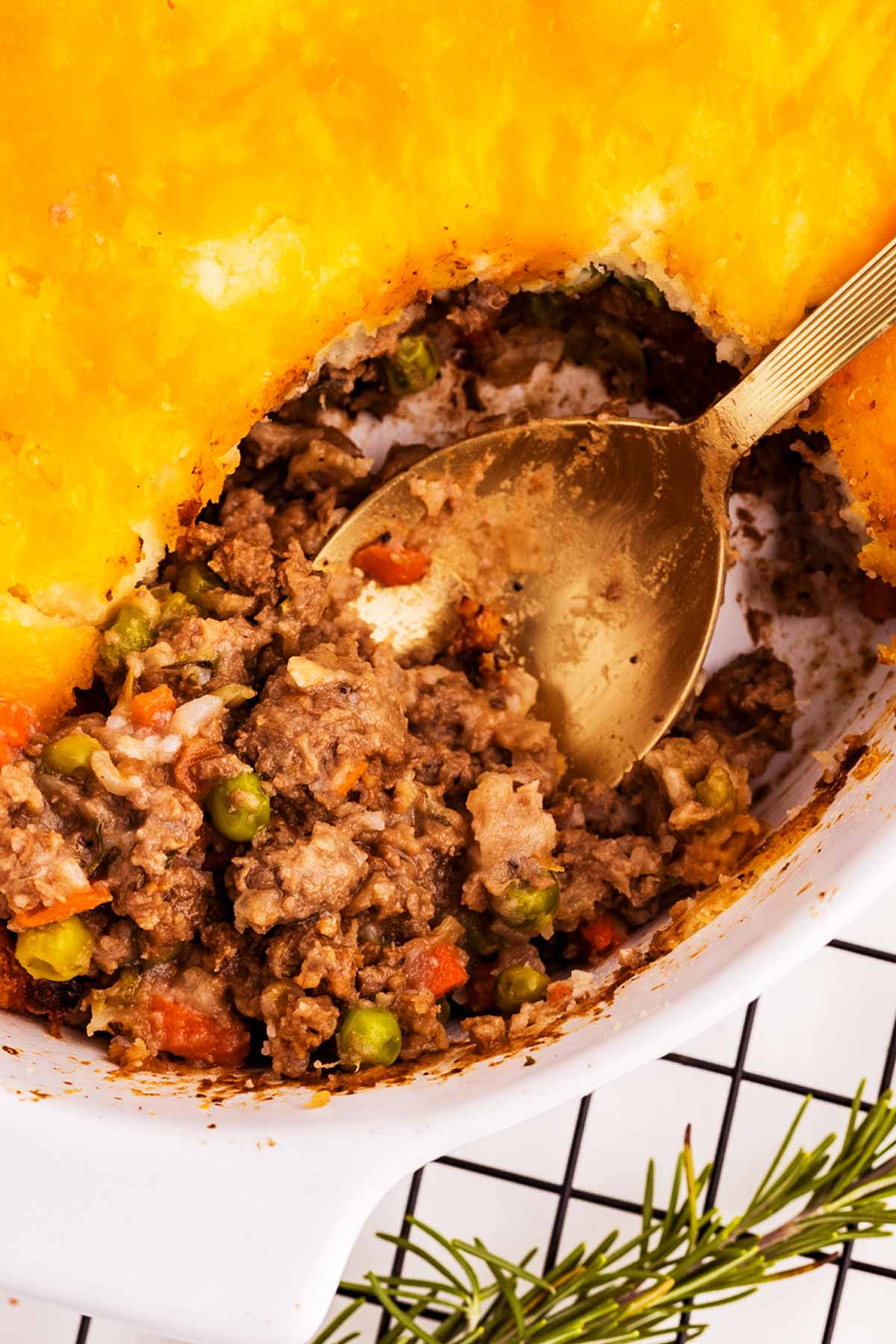 overhead close up view of spoon stuck in shepherd's pie