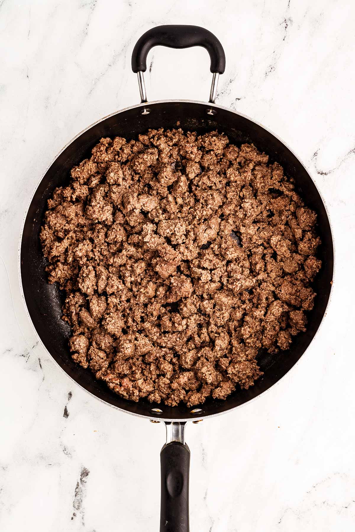 overhead view of browned ground beef in skillet