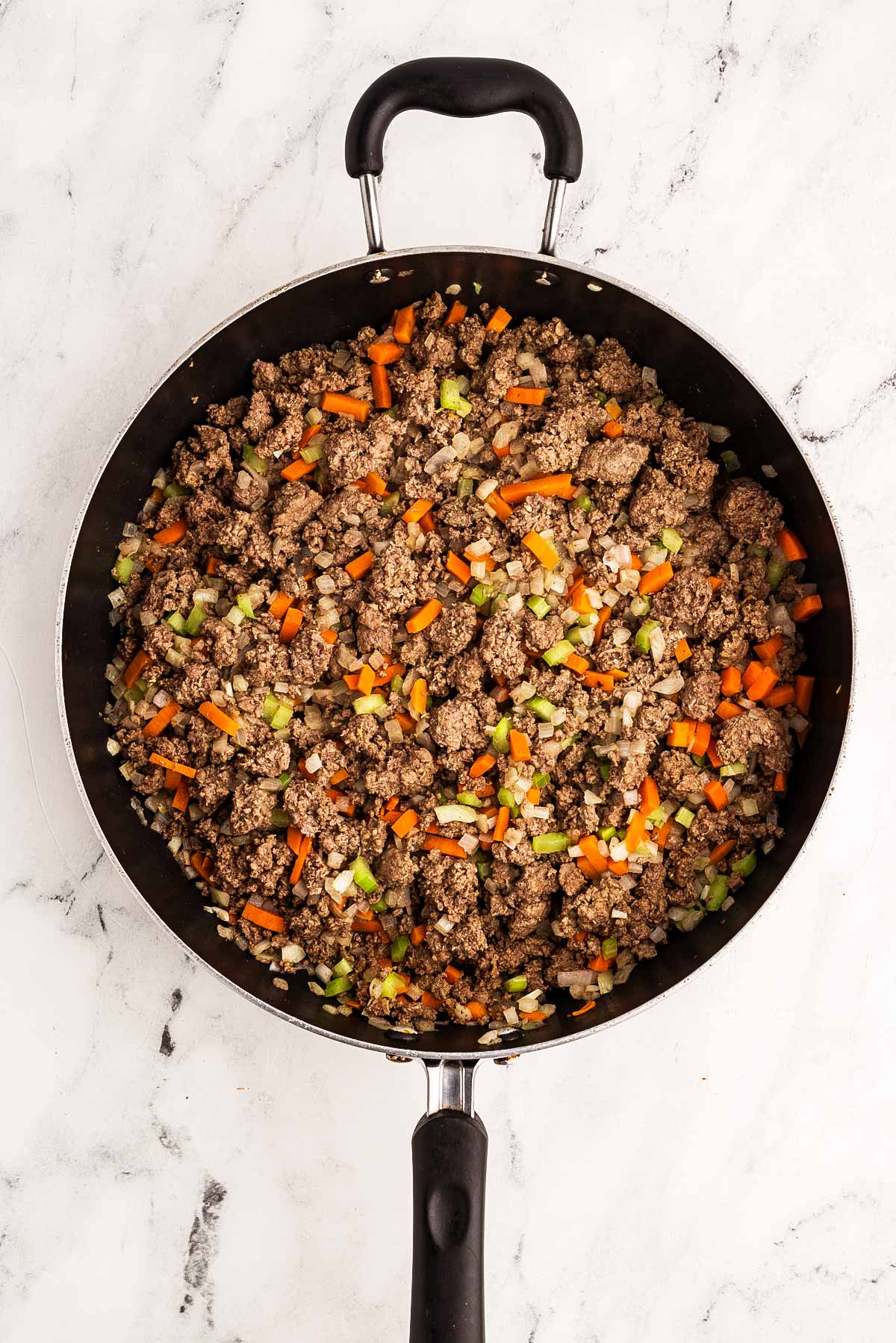 overhead view of browned ground beef mixture in skillet