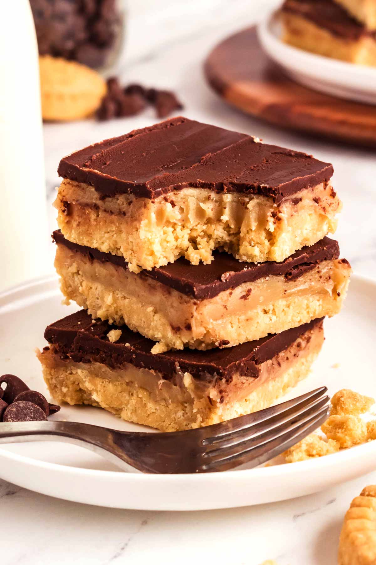 frontal view of stacked millionaire's shortbread bars on small white plate