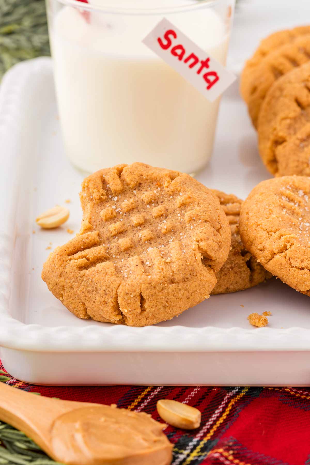 frontal view of peanut butter cookies in front of milk glass