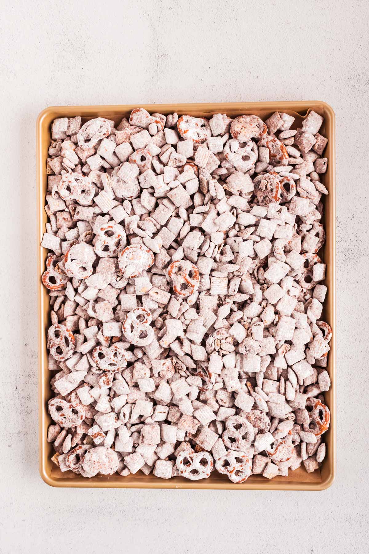 overhead view of reindeer chow without candy on baking sheet