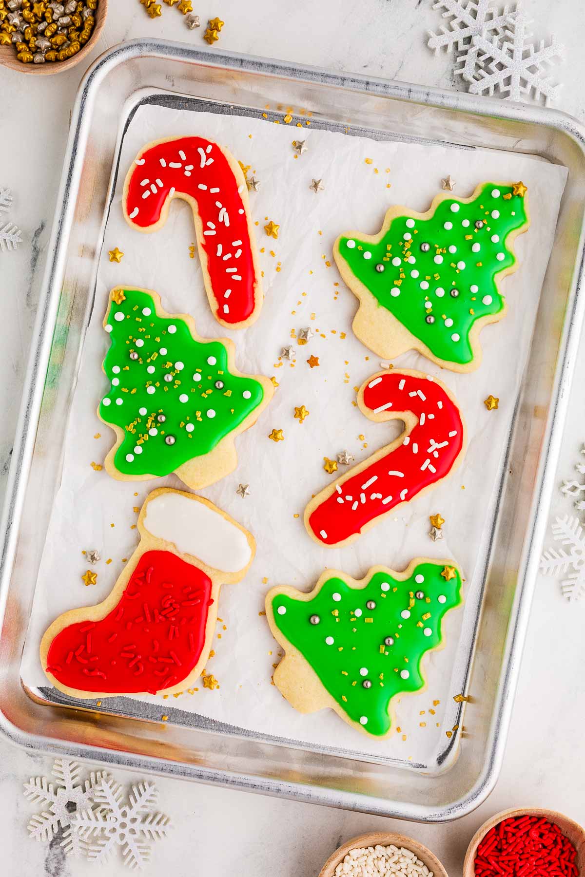 overhead view of christmas decorated sugar cookies on baking tray