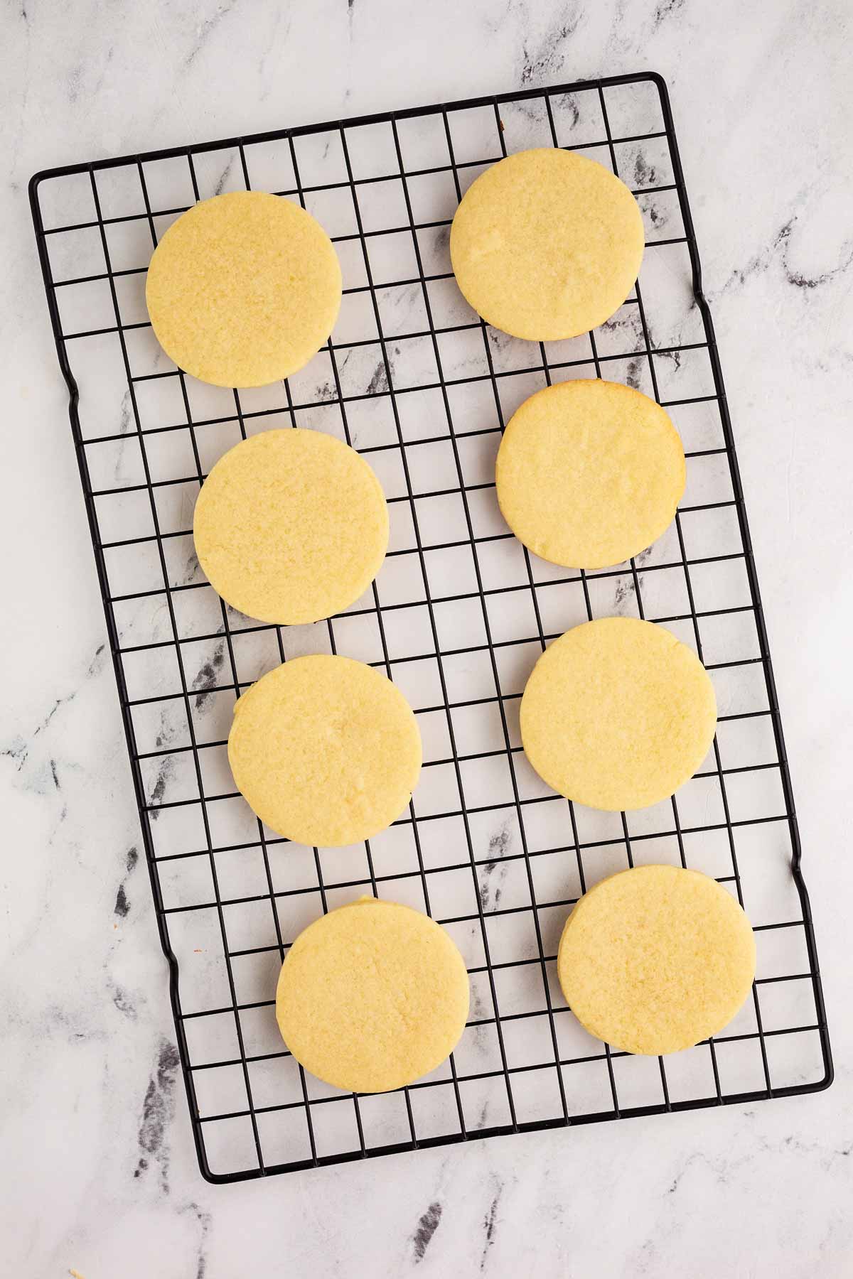 overhead view of baked sugar cookies on wire rack