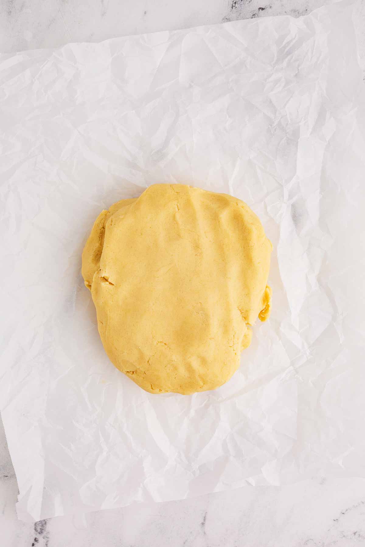 overhead view of sugar cookie dough on baking parchment