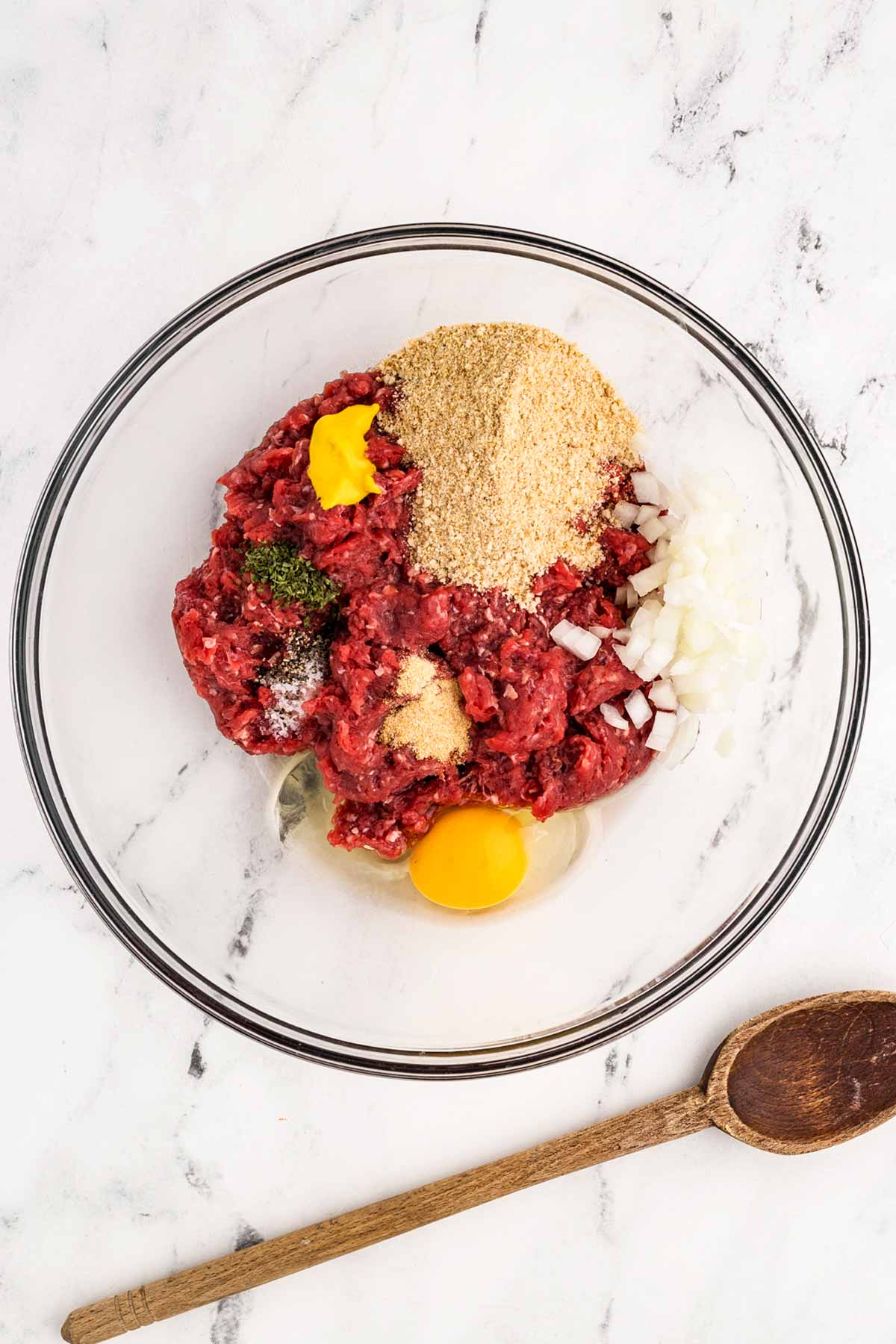 overhead view of meatball ingredients in glass bowl