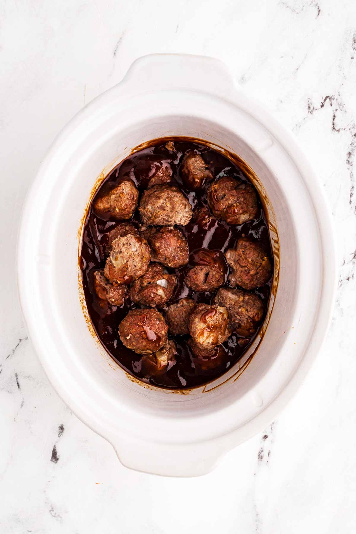 overhea view of meatballs and bbq sauce in crock