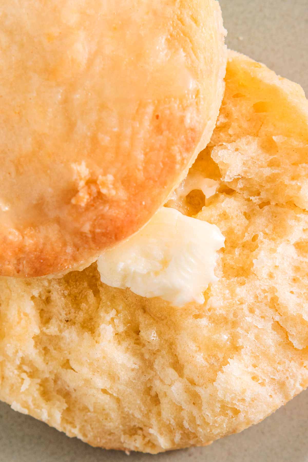 overhead view of split biscuit with butter