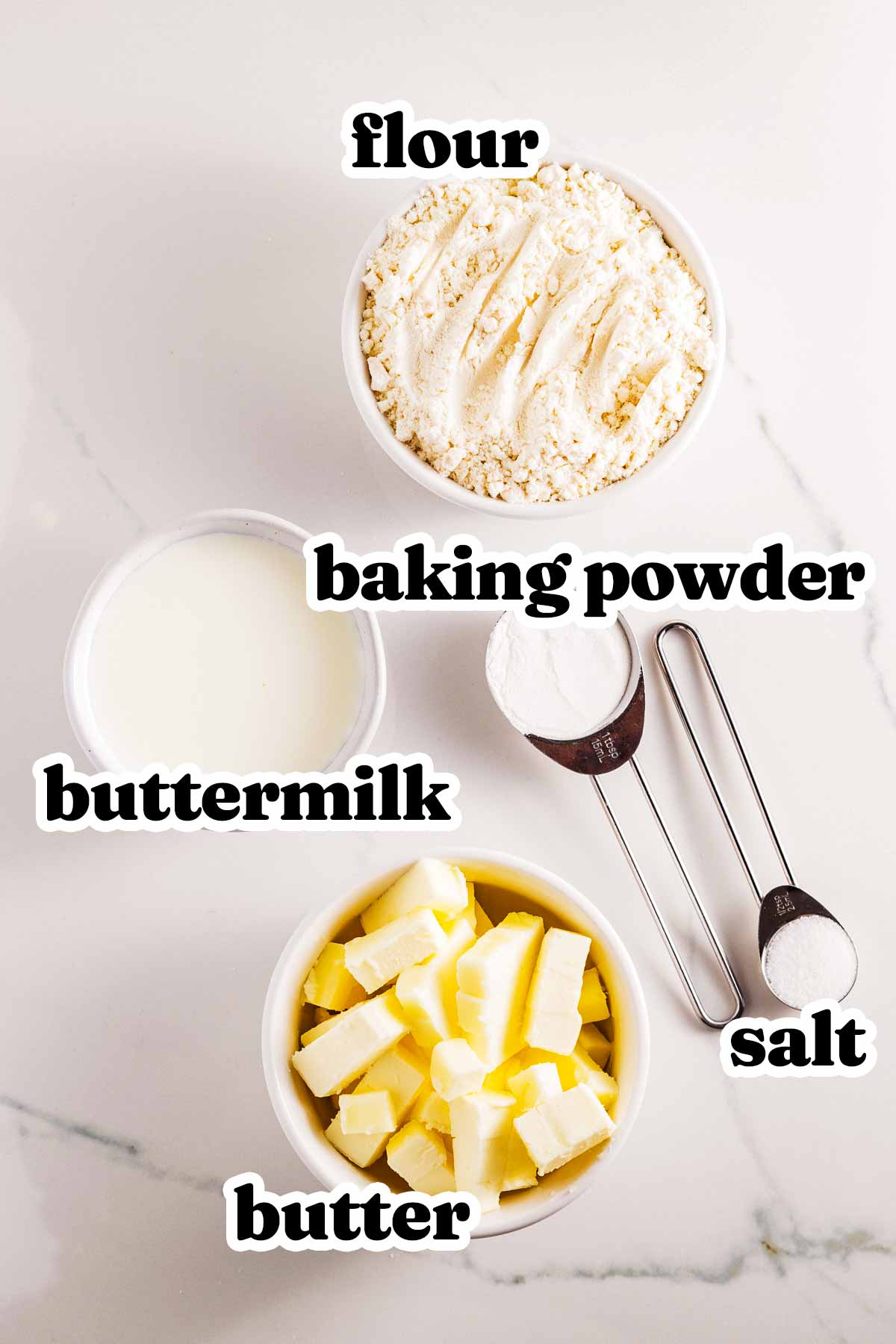 overhead view of ingredients to make buttermilk biscuits with text labels