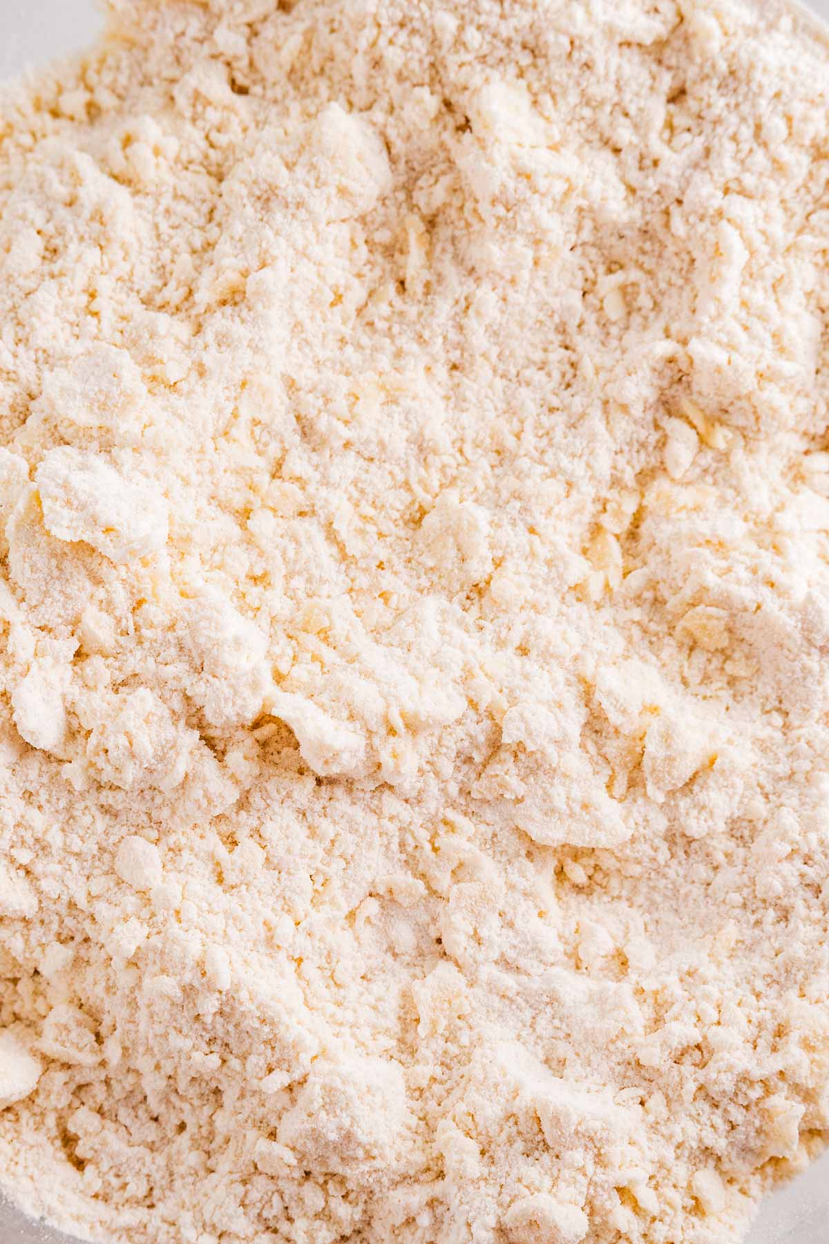 overhead close up view of butter cut into flour