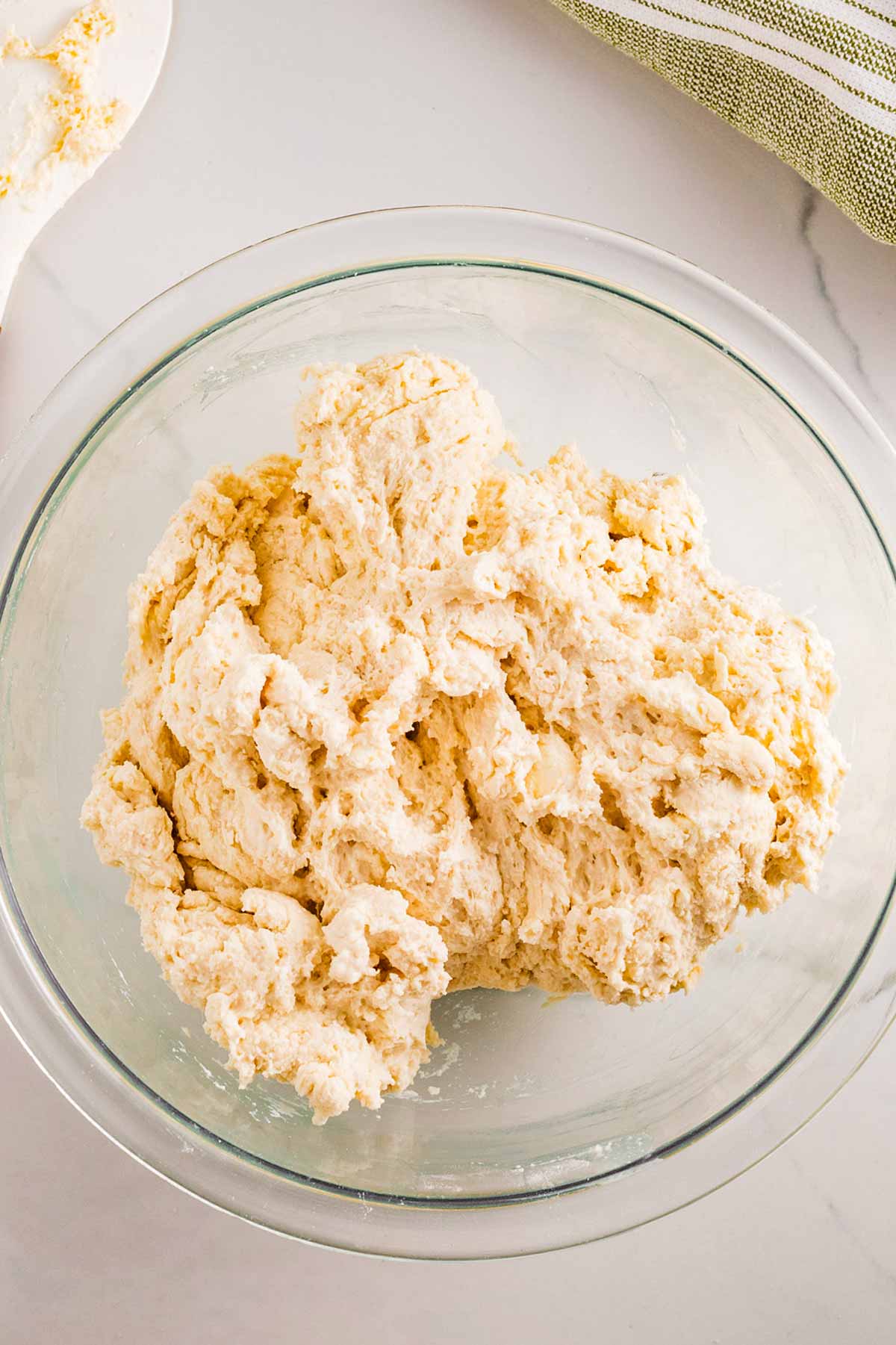 overhead view of homemade biscuit dough in glass bowl