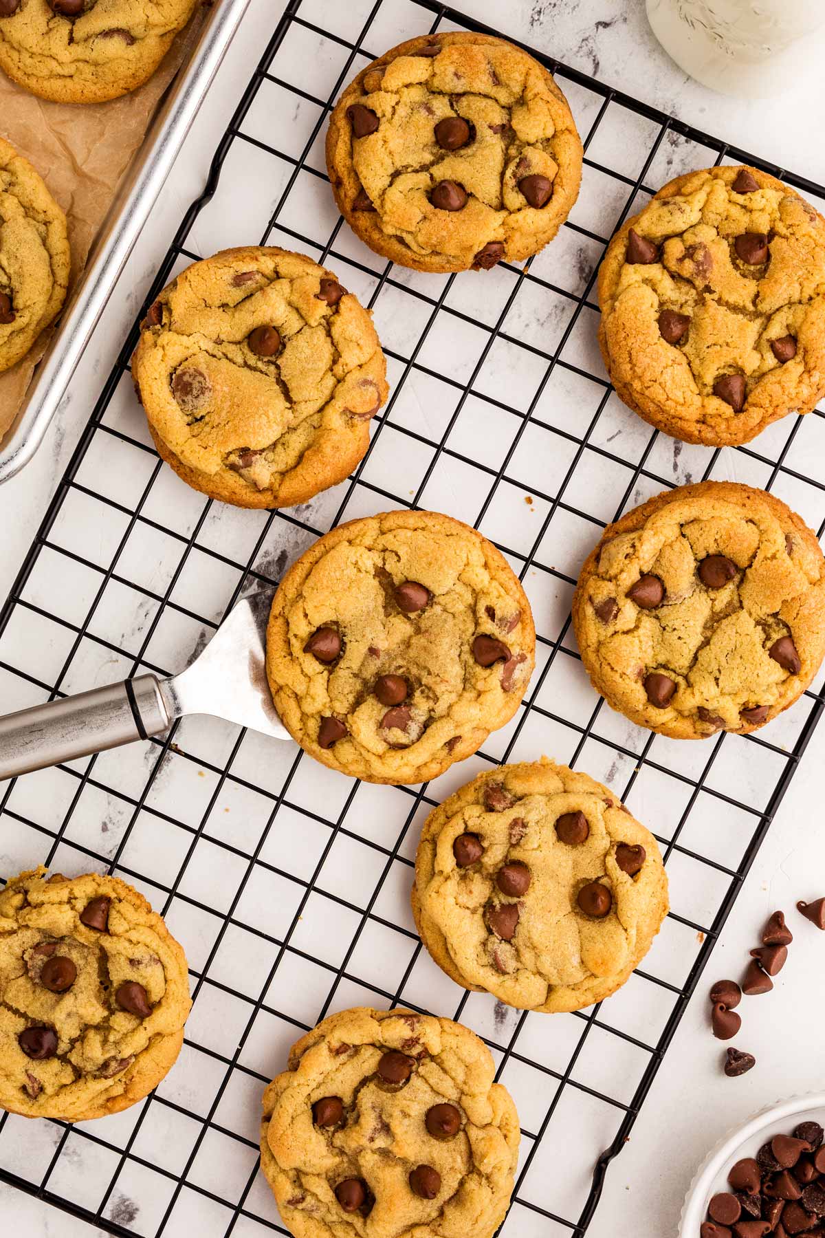 overhead view of chocolate chip cookies on black wire rack