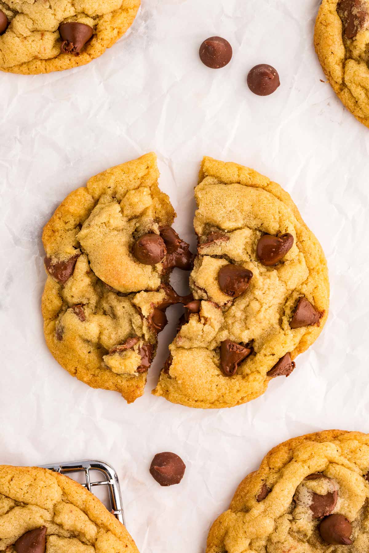 overhead view of split chocolate chip cookie with melted chocolate chips