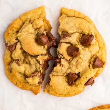 overhead view of split chocolate chip cookie with melted chocolate chips