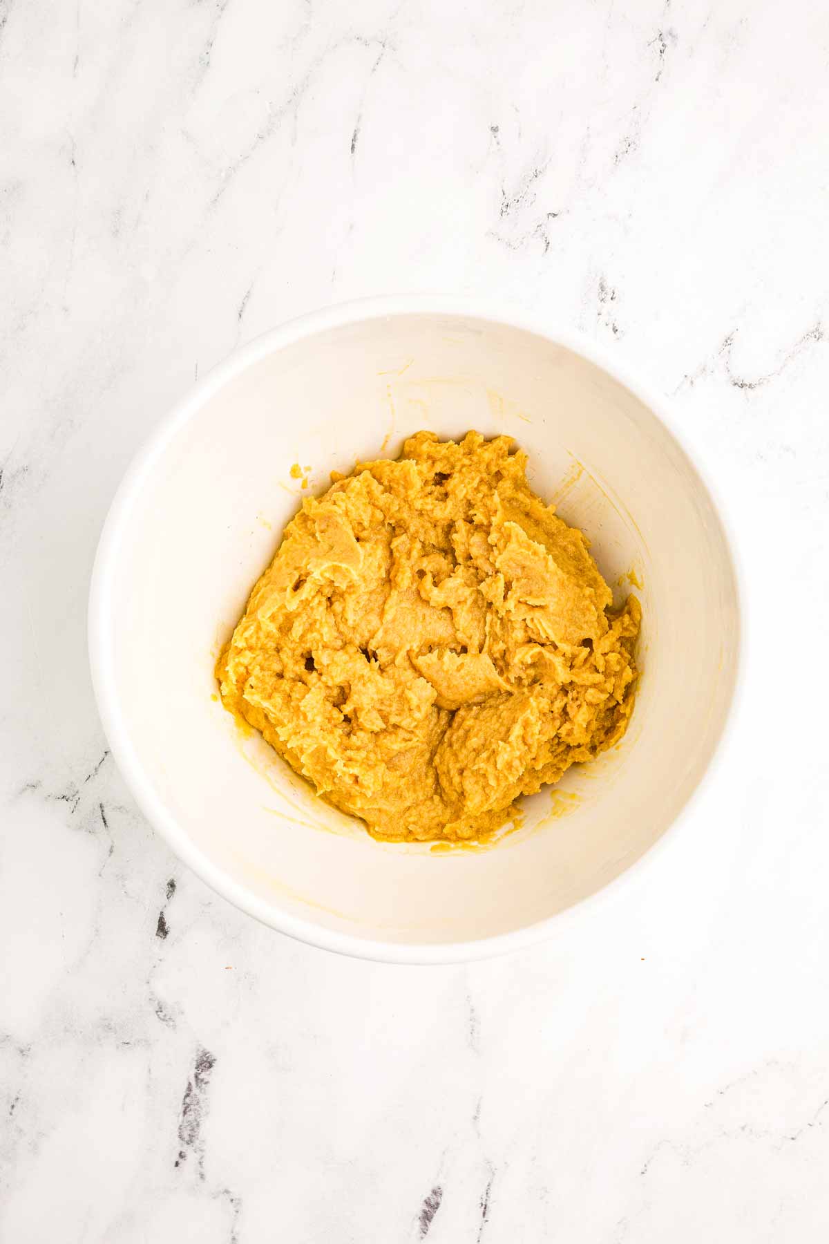 overhead view of creamed wet ingredients in white bowl