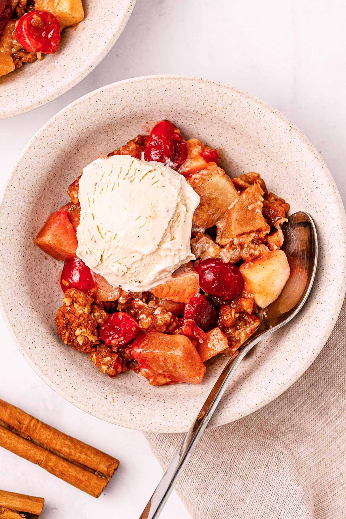 overhead view of cranberry apple crisp with ice cream