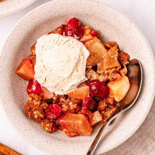 overhead view of cranberry apple crisp with ice cream