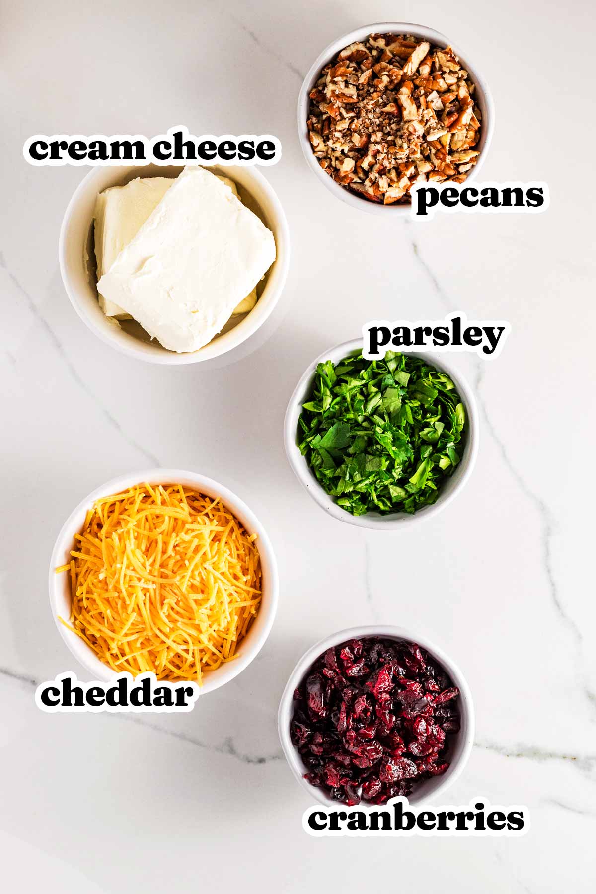 overhead view of ingredients to make cranberry pecan cheeseball with text labels