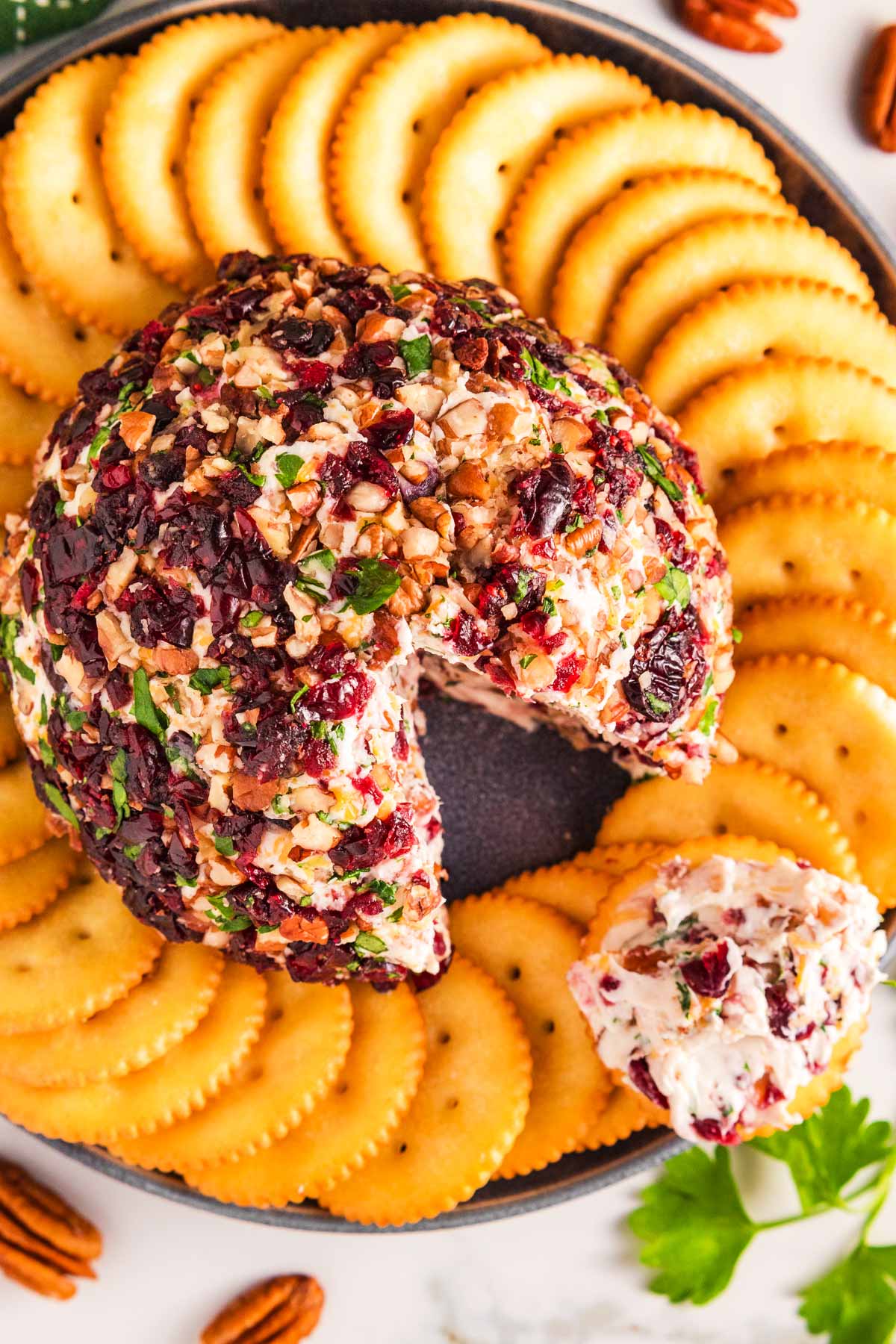 overhead view of cheeseball in middle of crackers