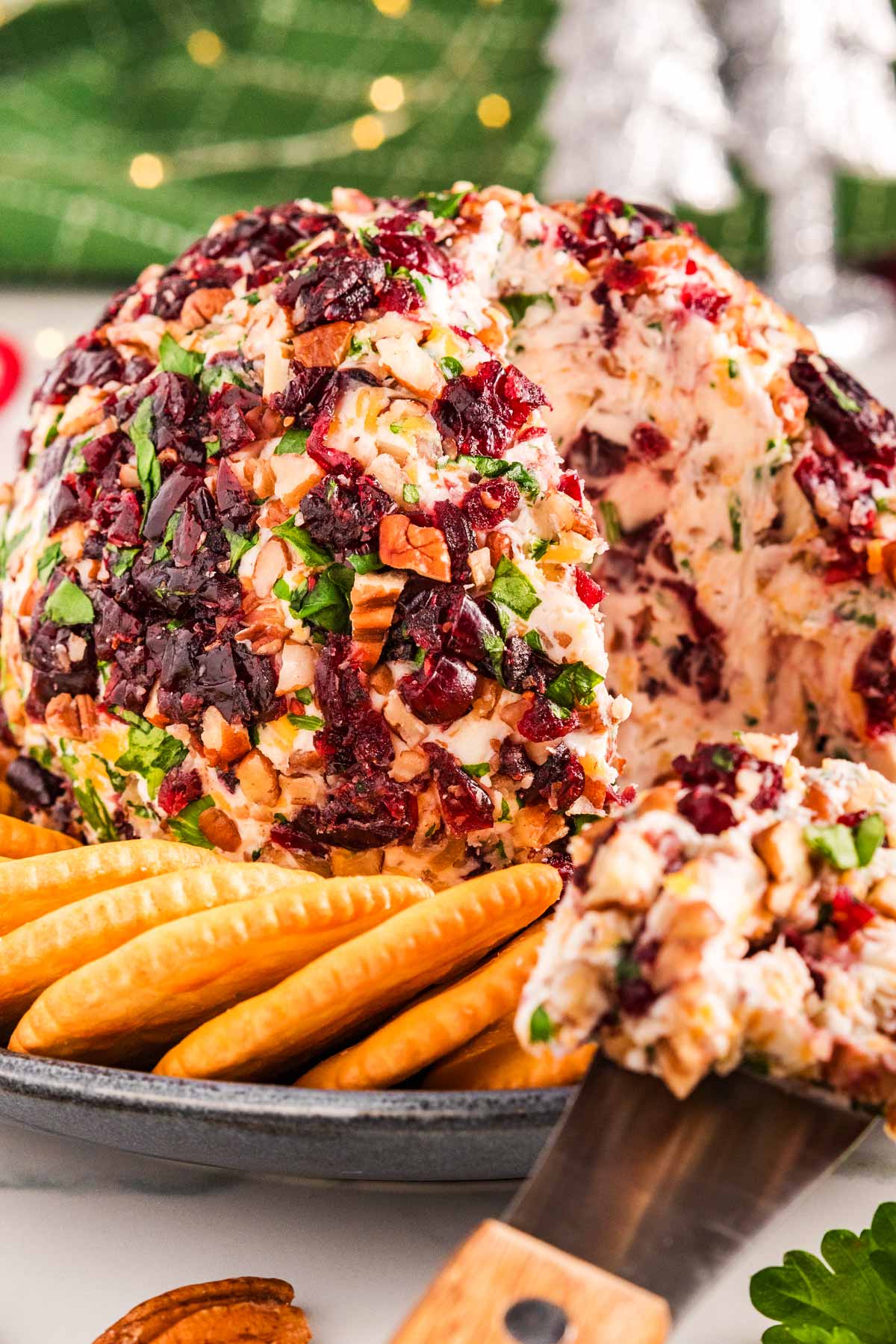 frontal view of cranberry pecan cheeseball surrounded by crackers