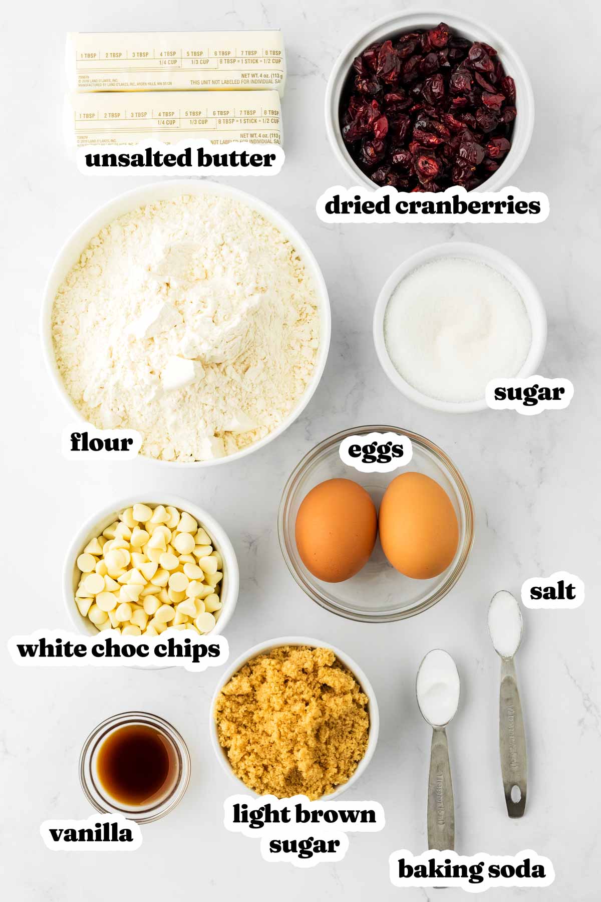 overhead view of ingredients to make cranberry white chocolate chip cookies with text labels