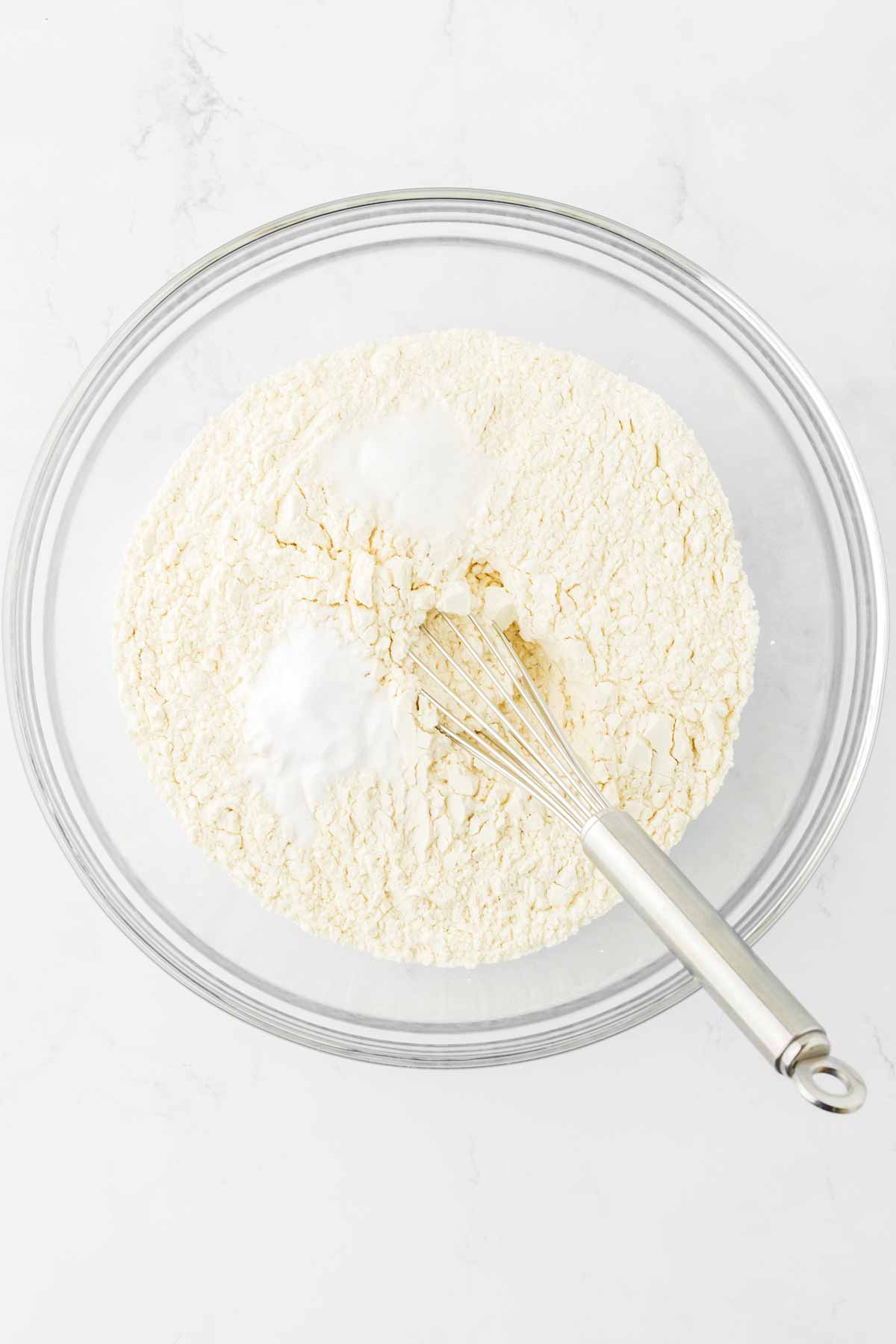 overhead view of dry cookie ingredients in glass bowl