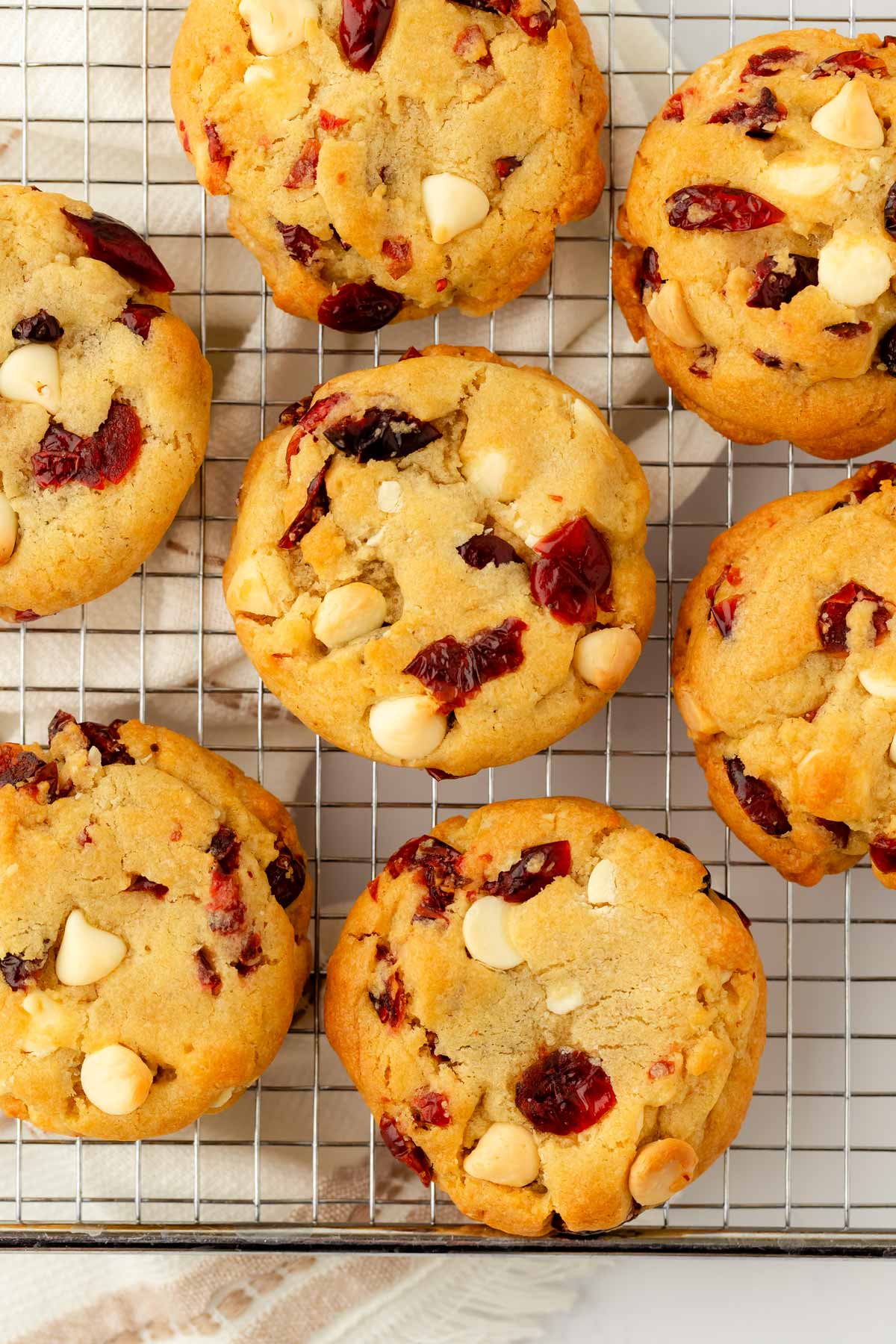 overhead view of cranberry white chocolate chip cookies on wire rack