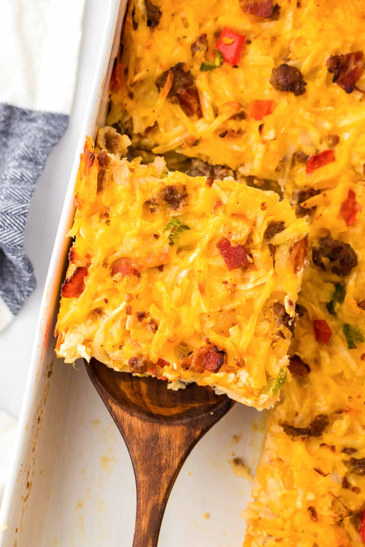 overhead view of hashbrown breakfast casserole on wooden spatula