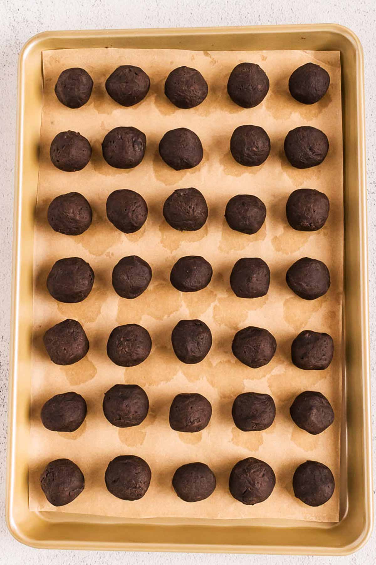 rolled oreo truffles on baking sheet after freezing