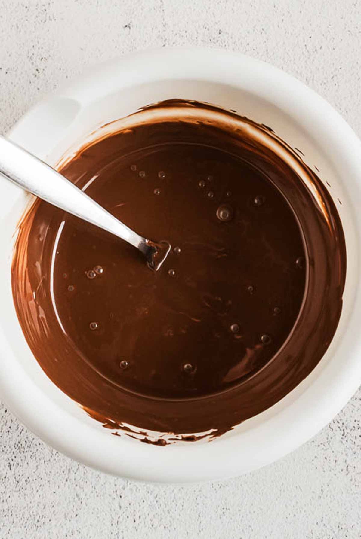 overhead view of melted chocolate in white bowl