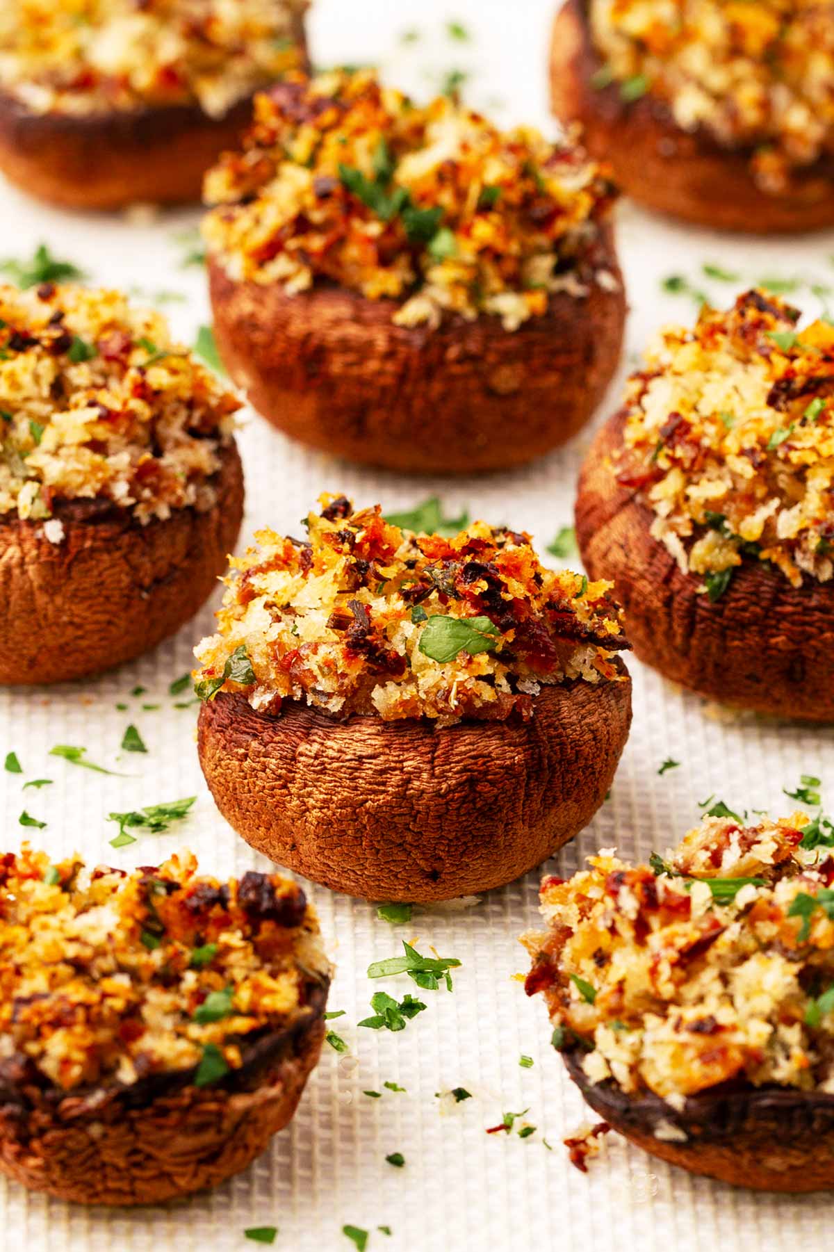 frontal view of stuffed mushrooms on white surface