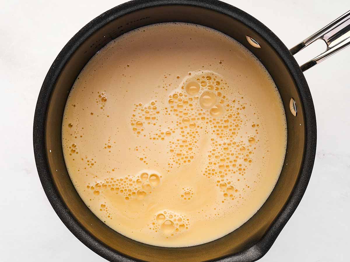 overhead view of beer and evaporated milk in saucepan before heating